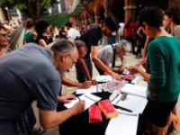 Image: people signing the Guanyem manifesto (via Guerrilla Translation).