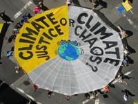 People around a climate change banner